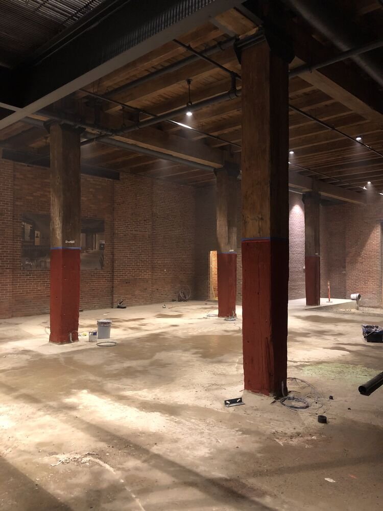 The lobby during fit out, with the original timber posts and their red painted bases
