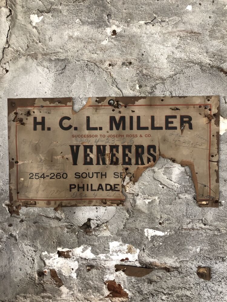 An H.C.L. Miller veneers sign found on the plaster at 1516 N 5th Street, with pencil dates from the 1920s