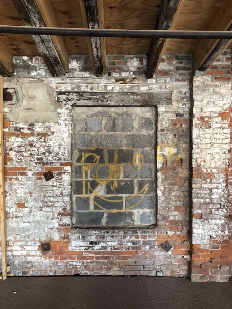 A bricked up window opening with its original timber lintel