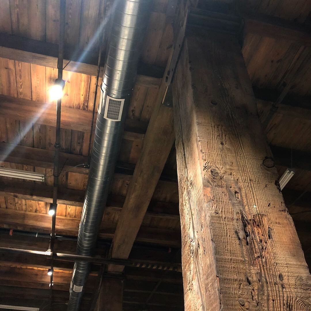 New ductwork run between the original timber beams in the Billy Penn Studios lobby, before painting