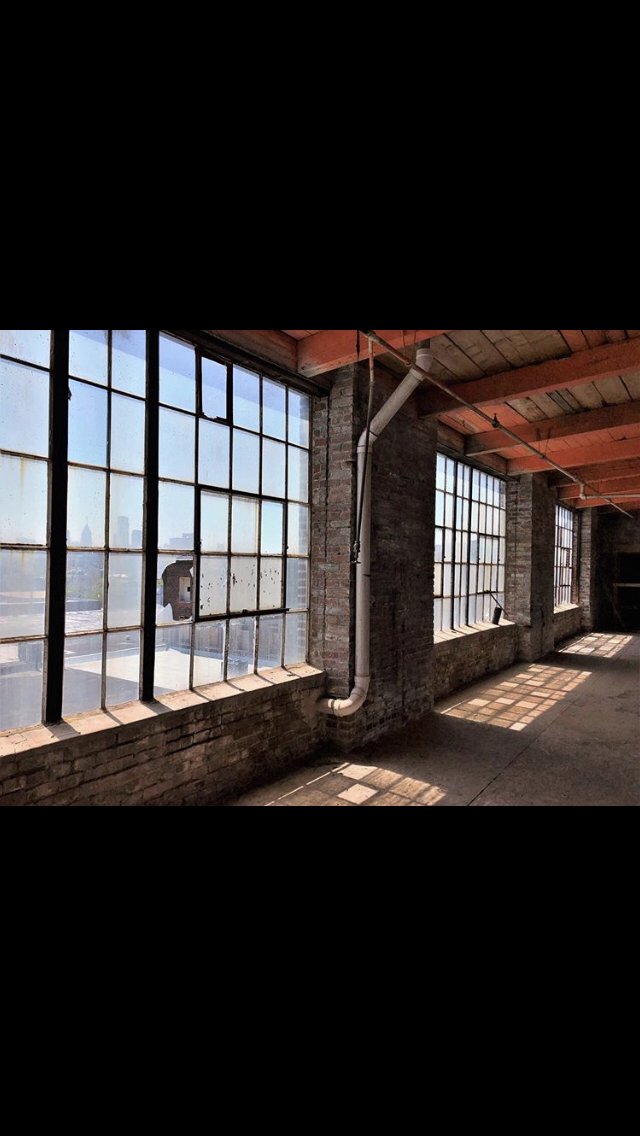 The original factory windows in Unit 506 at Billy Penn Studios before restoration