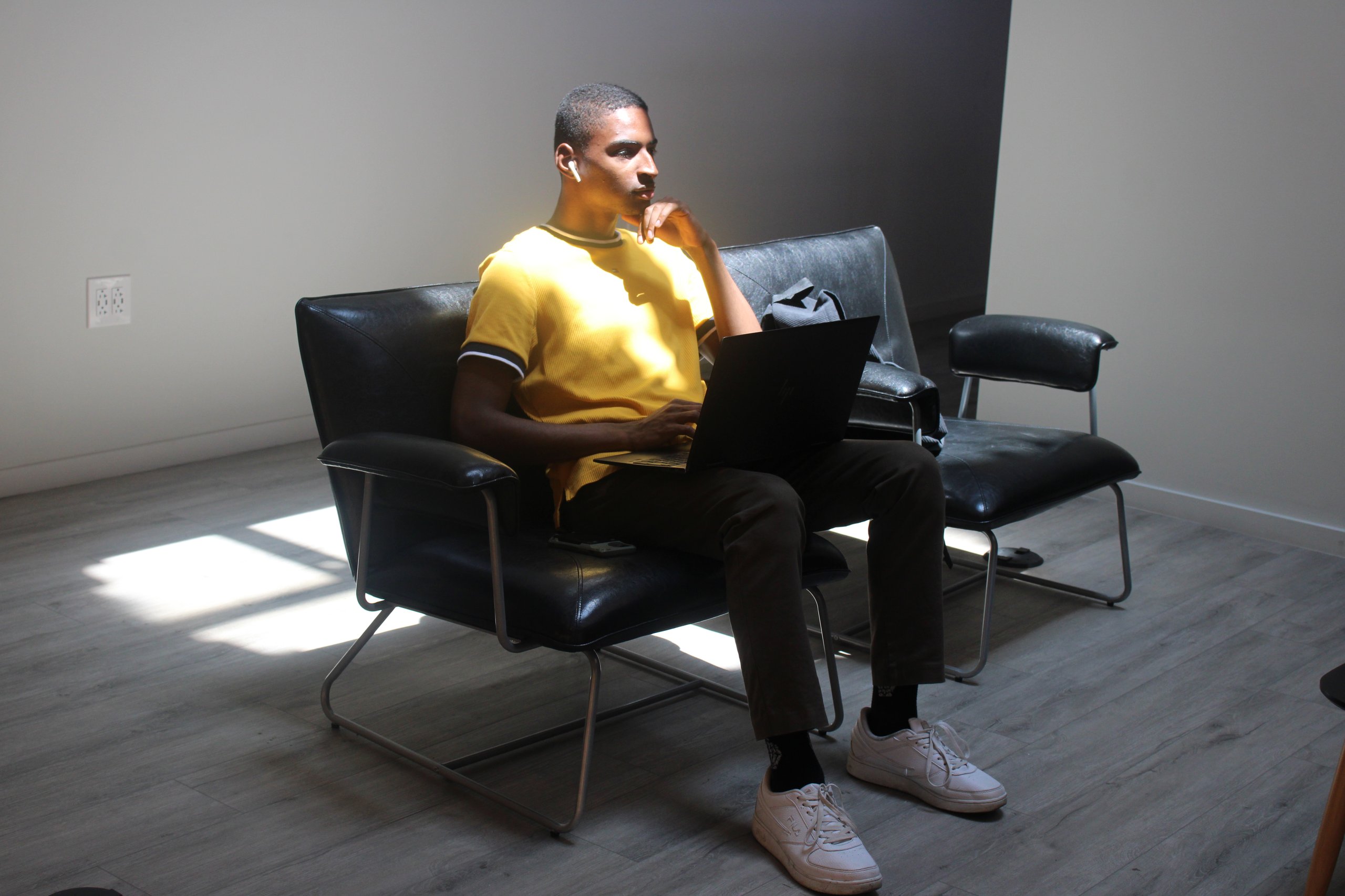 A member working in the naturally lit coworking lounge at Billy Penn Studios