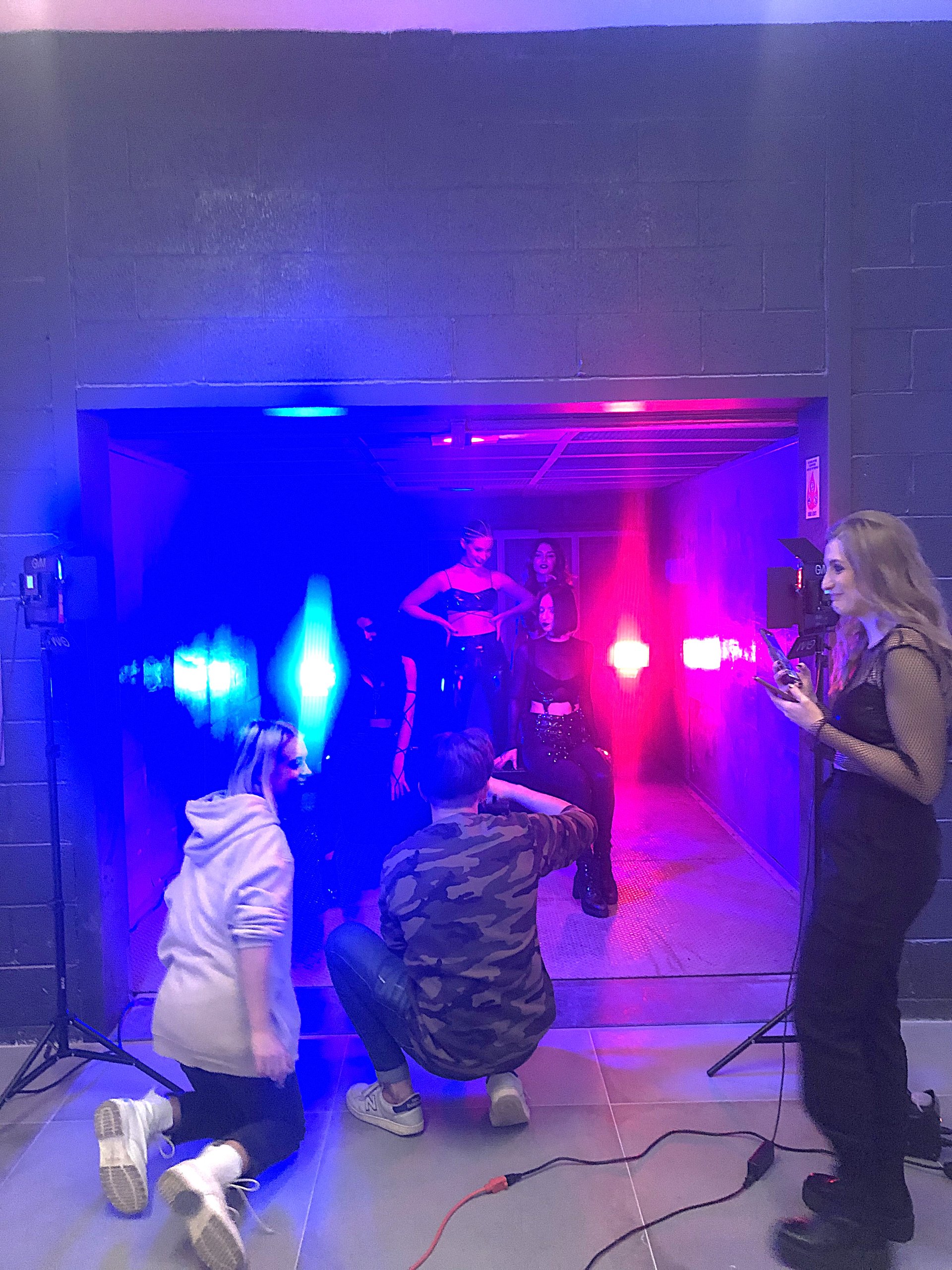A scene shot in the freight elevator at Billy Penn Studios, lit in neon