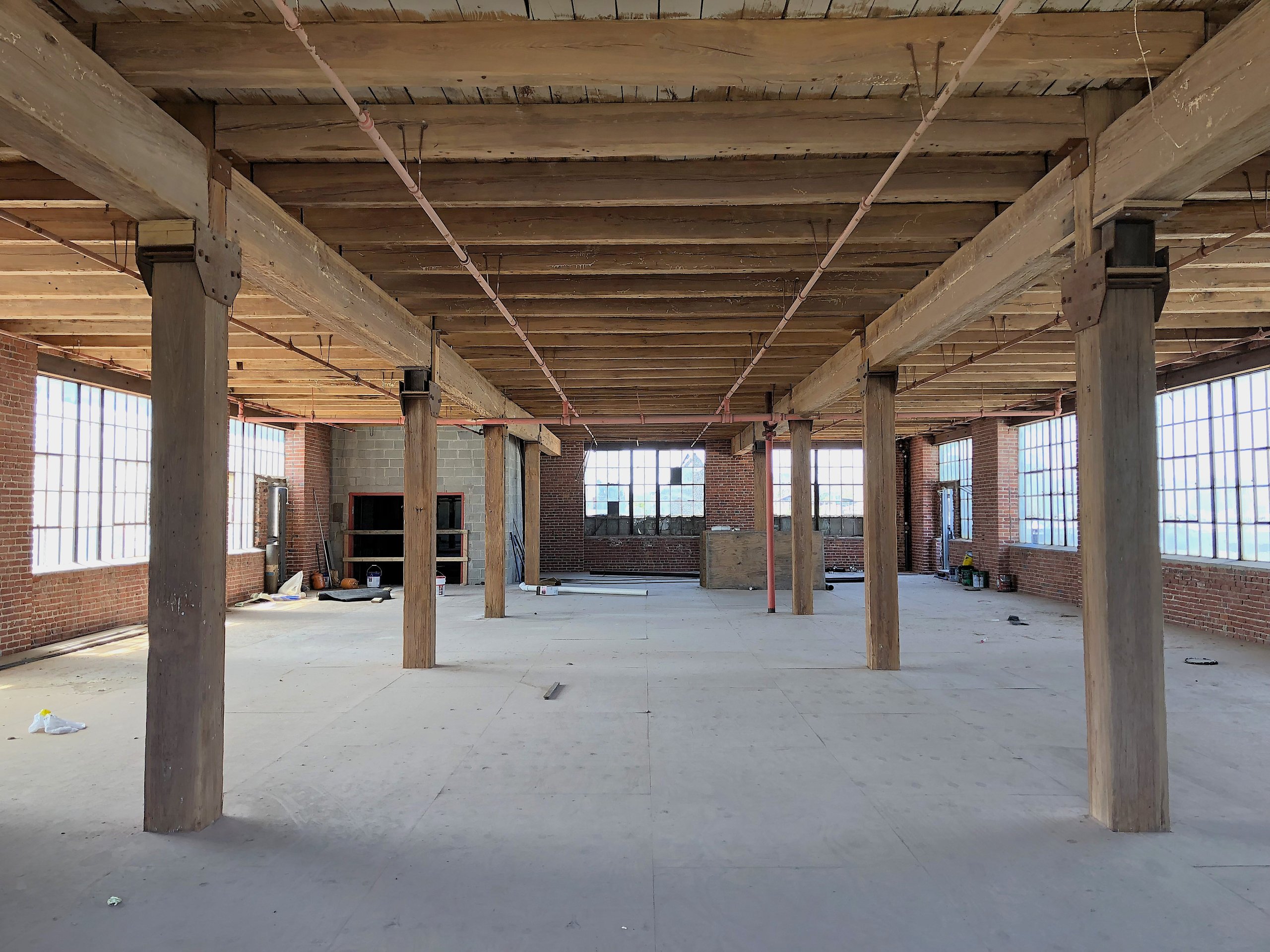 The fourth floor of the 1922 section at Billy Penn Studios before restoration, timber posts and plank floors