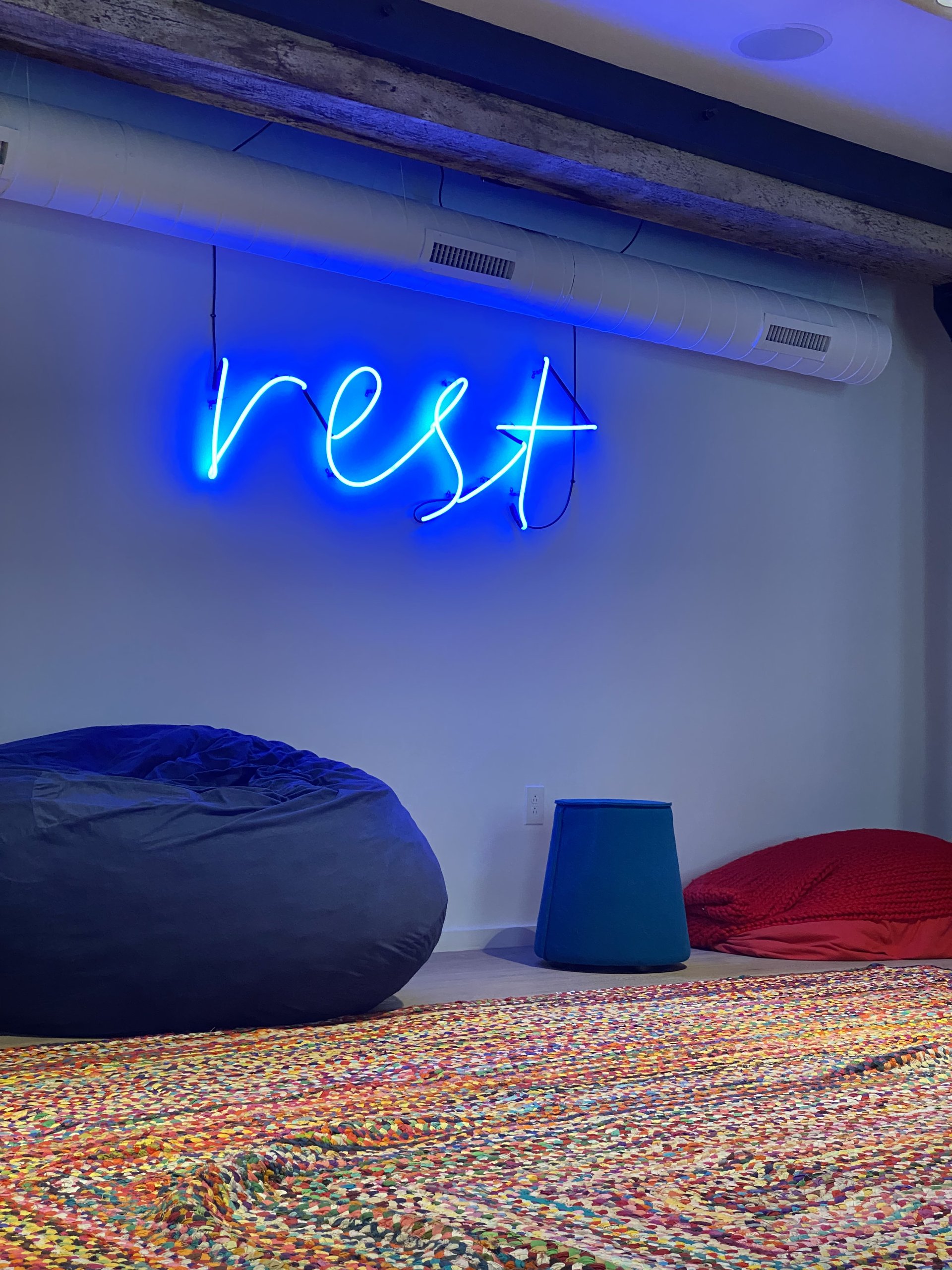 A neon sign in the common areas at Billy Penn Studios