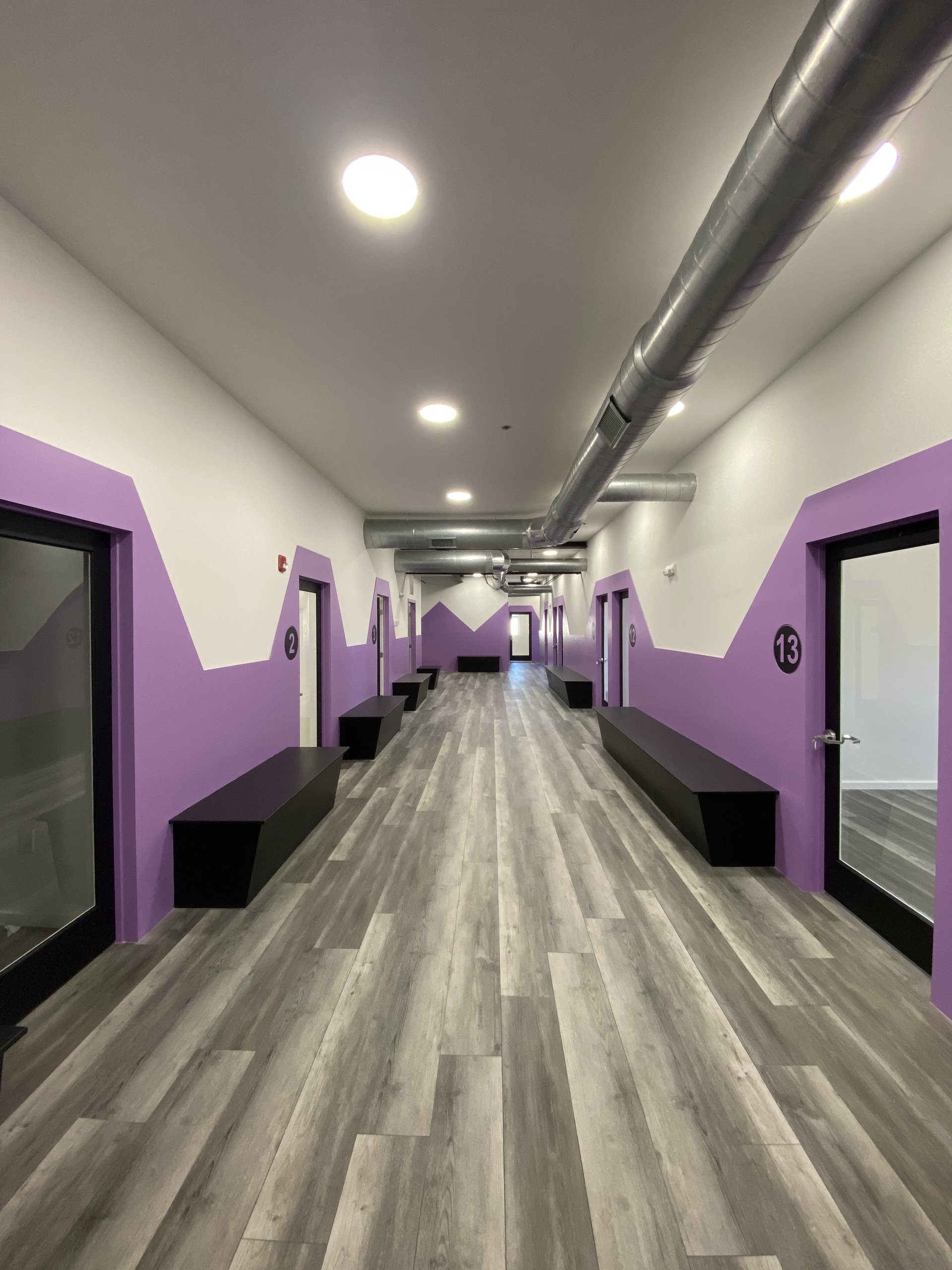 A hallway of numbered private salon suites at Billy Penn Studios in Olde Kensington, Philadelphia, near Fishtown and Northern Liberties